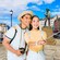 Two tourists holding cameras and a selfie stick on a cobblestone road